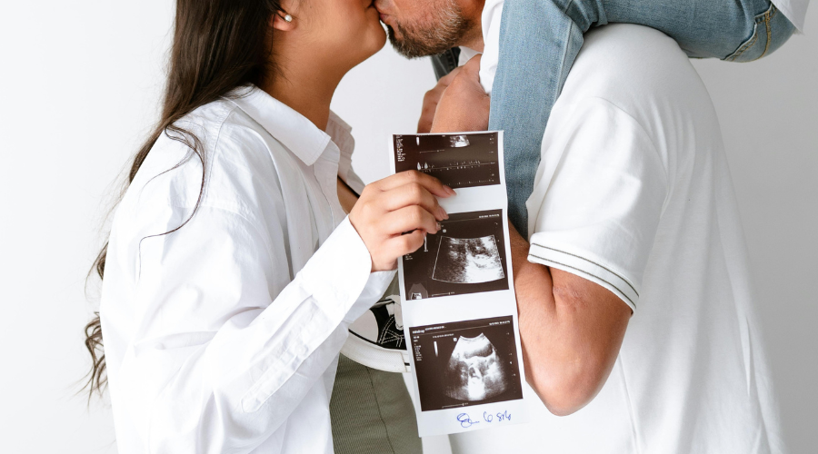 Happy Family With Ultrasound Of Fetus Photos